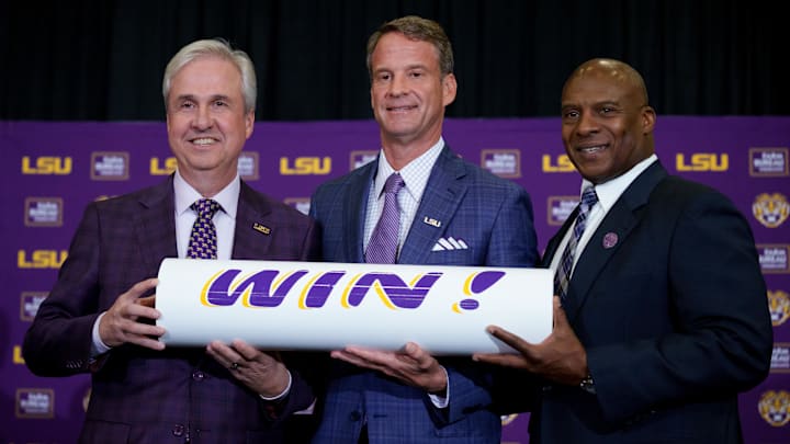Dec 1, 2025; Baton Rouge, LA, USA; LSU president Wade Rousse, left, LSU new head coach Lane Kiffin and LSU athletic director Verge Ausberry stand together at South Stadium Club at Tiger Stadium. Mandatory Credit: Matthew Hinton-Imagn Images