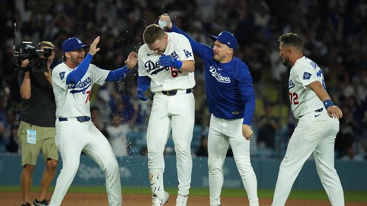 Los Angeles Dodgers catcher Dalton Rushing (68) celebrates with second baseman Alex Freeland (76), second baseman Miguel Rojas (72) and Kike Hernandez after hitting a walk-off single in the 11th inning against the Colorado Rockies at Dodger Stadium on July 6. Los Angeles Dodgers catcher Dalton Rushing (68) celebrates with second baseman Alex Freeland (76), second baseman Miguel Rojas (72) and Kike Hernandez after hitting a walk-off single in the 11th inning against the Colorado Rockies at Dodger Stadium on July 6.