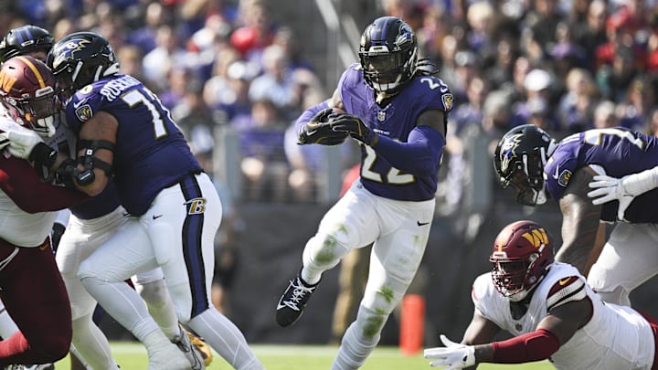 Oct 13, 2024; Baltimore, Maryland, USA;  Baltimore Ravens running back Derrick Henry (22) rushes through the hole during the first half against the Washington Commanders at M&T Bank Stadium. Mandatory Credit: Tommy Gilligan-Imagn Images
