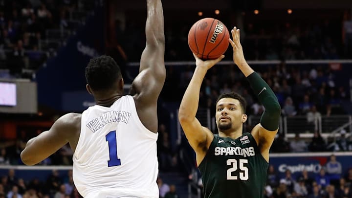 Mar 31, 2019; Washington, DC, USA; Duke Blue Devils forward Zion Williamson (1) prepares to block the shot of Michigan State Spartans forward Kenny Goins (25) in the championship game of the east regional of the 2019 NCAA Tournament at Capital One Arena. Mandatory Credit: Geoff Burke-Imagn Images