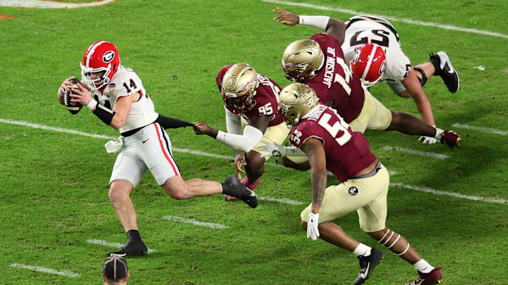Dec 30, 2023; Miami Gardens, FL, USA; Florida State Seminoles defensive lineman Daniel Lyons (95) tackles Georgia Bulldogs quarterback Gunner Stockton (14) during the second half in the 2023 Orange Bowl at Hard Rock Stadium. Mandatory Credit: Sam Navarro-Imagn Images Dec 30, 2023; Miami Gardens, FL, USA; Florida State Seminoles defensive lineman Daniel Lyons (95) tackles Georgia Bulldogs quarterback Gunner Stockton (14) during the second half in the 2023 Orange Bowl at Hard Rock Stadium. Mandatory Credit: Sam Navarro-Imagn Images