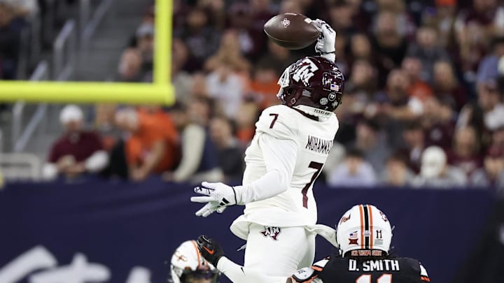 Dec 27, 2023; Houston, TX, USA; Texas A&M Aggies wide receiver Moose Muhammad III (7) catches a pass against Oklahoma State Cowboys cornerback Dylan Smith (11) in the second quarter at NRG Stadium. Mandatory Credit: Thomas Shea-Imagn Images