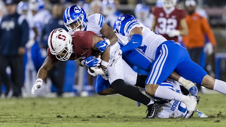 Nov 26, 2022; Stanford, California, USA;  Stanford Cardinal wide receiver Elijah Higgins (6) is tackled by Brigham Young Cougars defensive back Micah Harper (1) during the first half at Stanford Stadium. Mandatory Credit: John Hefti-Imagn Images