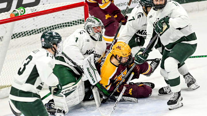Michigan State's goalie Trey Augustine, left, fights off Minnesota's Aaron Huglen, right, during the first period on Friday, Jan. 26, 2024, at Munn Arena in East Lansing. Michigan State's goalie Trey Augustine, left, fights off Minnesota's Aaron Huglen, right, during the first period on Friday, Jan. 26, 2024, at Munn Arena in East Lansing.