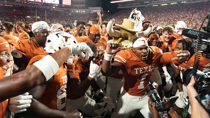 Texas defensive end Colin Simmons (1) celebrates with teammates after defeating Ohio State. Texas defensive end Colin Simmons (1) celebrates with teammates after defeating Ohio State.
