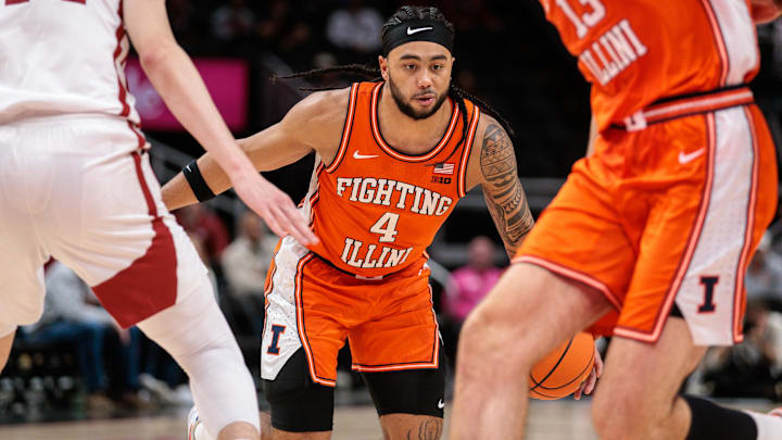 Nov 28, 2024; Kansas City, Missouri, USA; Illinois Fighting Illini guard Kylan Boswell (4) drives to the basket during the second half against the Arkansas Razorbacks at T-Mobile Center. Mandatory Credit: William Purnell-Imagn Images