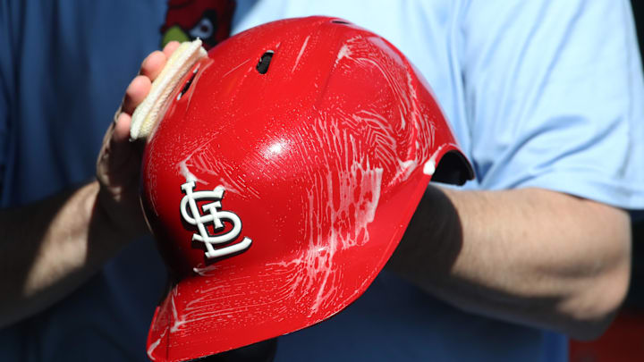 Apr 9, 2025; Pittsburgh, Pennsylvania, USA;  The St. Louis Cardinals equipment manger scrubs the team batting helmets before the game against the Pittsburgh Pirates at PNC Park. Mandatory Credit: Charles LeClaire-Imagn Images