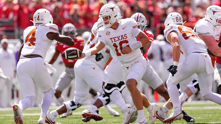 Texas Longhorns quarterback Arch Manning (16) hands off to running back CJ Baxter (4) during the NCAA football game against the Ohio State Buckeyes at Ohio Stadium on Aug. 30, 2025.