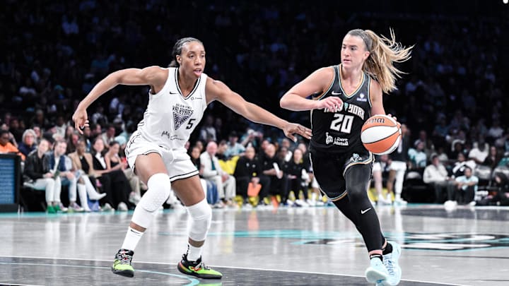 May 29, 2025; Brooklyn, New York, USA;New York Liberty guard Sabrina Ionescu (20) drives to the basket while being defended by Golden State Valkyries forward Kayla Thornton (5)  during the second half at Barclays Center. Mandatory Credit: John Jones-Imagn Images