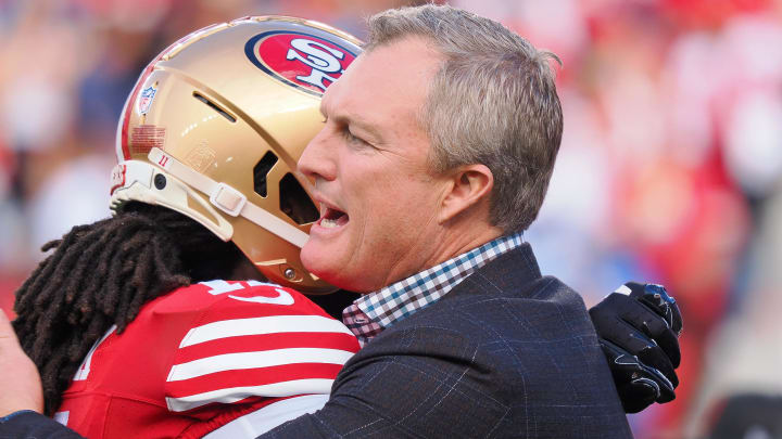 Jan 28, 2024; Santa Clara, California, USA; San Francisco 49ers general manager John Lynch hugs a player looks on before the NFC Championship football game against the Detroit Lions at Levi's Stadium. Mandatory Credit: Kelley L Cox-USA TODAY Sports