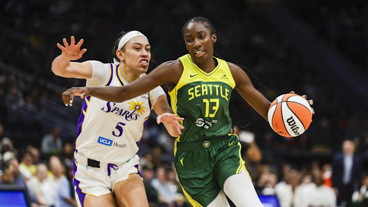 Sep 1, 2025; Seattle, Washington, USA; Seattle Storm forward Ezi Magbegor (13) dribbles against Los Angeles Sparks forward Dearica Hamby (5) during the second quarter at Climate Pledge Arena. Mandatory Credit: Joe Nicholson-Imagn Images