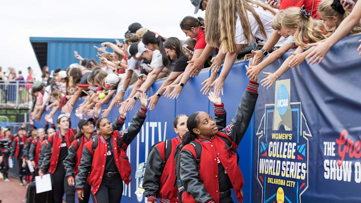 Jun 4, 2025; Oklahoma City, OK, USA;  Texas Tech Red Raiders players enter the stadium before their game against Texas Longhorns in game one of the NCAA Softball Women's College World Series finals at Devon Park. Mandatory Credit: Brett Rojo-Imagn Images