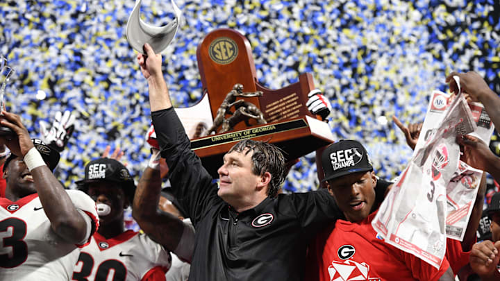 Dec 2, 2017; Atlanta, GA, USA; Georgia Bulldogs head coach Kirby Smart reacts as his players lift the Southeastern Conference trophy after a victory over the Auburn Tigers in the SEC Championship game at Mercedes-Benz Stadium. Georgia defeated Auburn 28-7. Mandatory Credit: John David Mercer-Imagn Images Dec 2, 2017; Atlanta, GA, USA; Georgia Bulldogs head coach Kirby Smart reacts as his players lift the Southeastern Conference trophy after a victory over the Auburn Tigers in the SEC Championship game at Mercedes-Benz Stadium. Georgia defeated Auburn 28-7. Mandatory Credit: John David Mercer-Imagn Images