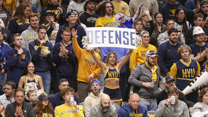 Feb 25, 2025; Morgantown, West Virginia, USA; A West Virginia Mountaineers cheerleader performs during the second half against the TCU Horned Frogs at WVU Coliseum. Mandatory Credit: Ben Queen-Imagn Images