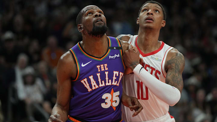 Mar 30, 2025; Phoenix, Arizona, USA; Phoenix Suns forward Kevin Durant (35) and Houston Rockets forward Jabari Smith Jr. (10) fight for position in the first half at Footprint Center. Mandatory Credit: Rick Scuteri-Imagn Images