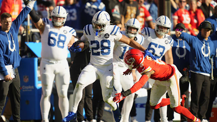 Nov 23, 2025; Kansas City, Missouri, USA;  Indianapolis Colts running back Jonathan Taylor (28) runs against Kansas City Chiefs safety Bryan Cook (6) in the second half at GEHA Field at Arrowhead Stadium. 