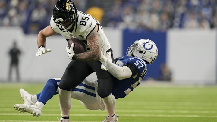 Jan 5, 2025; Indianapolis, Indiana, USA; Indianapolis Colts linebacker Jaylon Carlies (57) works to bring down Jacksonville Jaguars tight end Luke Farrell (89) during a game against the Jacksonville Jaguars at Lucas Oil Stadium. Mandatory Credit: Christine Tannous-USA TODAY Network via Imagn Images Jan 5, 2025; Indianapolis, Indiana, USA; Indianapolis Colts linebacker Jaylon Carlies (57) works to bring down Jacksonville Jaguars tight end Luke Farrell (89) during a game against the Jacksonville Jaguars at Lucas Oil Stadium. Mandatory Credit: Christine Tannous-USA TODAY Network via Imagn Images