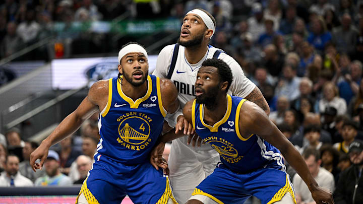 Dallas Mavericks center Daniel Gafford (21) and Golden State Warriors guard Moses Moody (4) and forward Andrew Wiggins (22) look for the ball during the first half at the American Airlines Center. Mandatory Credit: Jerome Miron-Imagn Images