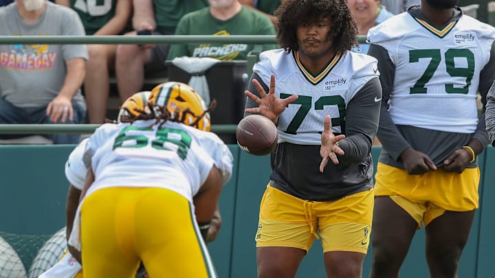 Green Bay Packers offensive lineman John Williams (73) catches a snap in a drill during practice on Tuesday, August 12, 2025, at Ray Nitschke Field in Ashwaubenon, Wis. 
Tork Mason/USA TODAY NETWORK-Wisconsin