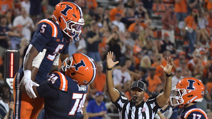 Sep 13, 2025; Champaign, Illinois, USA; Illinois Fighting Illini offensive lineman J.C. Davis (74) lifts Illinois Fighting Illini running back Ca'Lil Valentine (5) after he scored a touchdown against the Western Michigan Broncos at Memorial Stadium. Mandatory Credit: Ron Johnson-Imagn Images Sep 13, 2025; Champaign, Illinois, USA; Illinois Fighting Illini offensive lineman J.C. Davis (74) lifts Illinois Fighting Illini running back Ca'Lil Valentine (5) after he scored a touchdown against the Western Michigan Broncos at Memorial Stadium. Mandatory Credit: Ron Johnson-Imagn Images