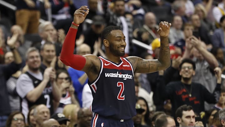 Dec 16, 2018; Washington, DC, USA; Washington Wizards guard John Wall (2) celebrates on the bench against the Los Angeles Lakers in the fourth quarter at Capital One Arena.  The Wizards won 128-110. Mandatory Credit: Geoff Burke-Imagn Images