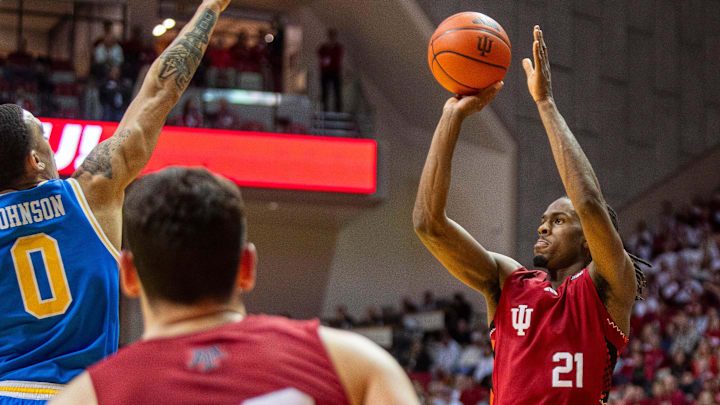 Indiana's Mackenzie Mgbako (21) shoots over UCLA's Kobe Johnson (0) at Simon Skjodt Assembly Hall. Indiana's Mackenzie Mgbako (21) shoots over UCLA's Kobe Johnson (0) at Simon Skjodt Assembly Hall.