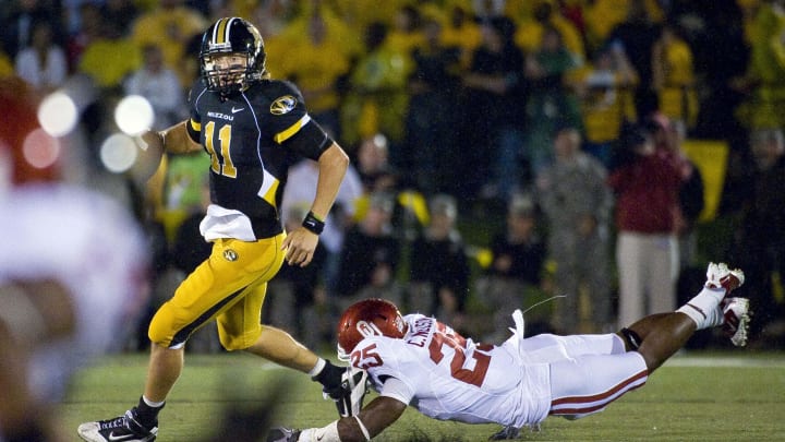 Oct 23, 2010; Columbia, MO, USA; Missouri Tigers quarterback Blaine Gabbert (11) avoids Oklahoma Sooners cornerback Emmanuel Jones (25) during the second half at Faurot Field at Memorial Stadium. Mandatory Credit: Photo by Scott Rovak-USA TODAY Sports