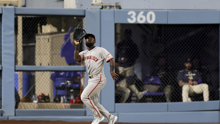 Jun 14, 2025; Los Angeles, California, USA;  San Francisco Giants left fielder Daniel Johnson catches a line out from Los Angeles Dodgers second baseman Hyeseong Kim during the seventh inning of a baseball game at Dodger Stadium. Mandatory Credit: Ryan Sun-Imagn Images