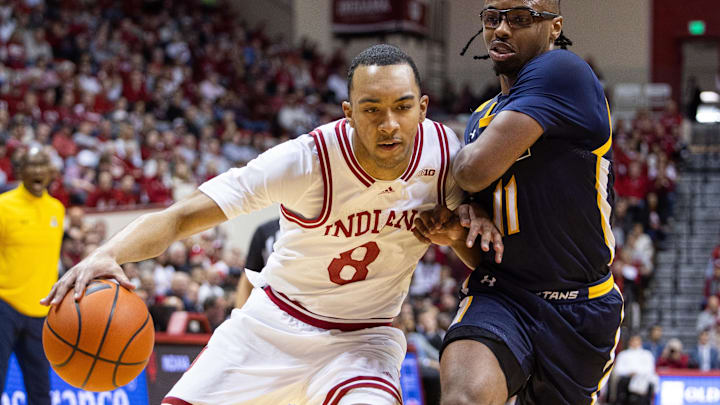 Indiana Hoosiers forward Bryson Tucker (8) dribbles the ball while UNC-Greensboro Spartans guard Ronald Polite III (11) defends in the first half at Simon Skjodt Assembly Hall.