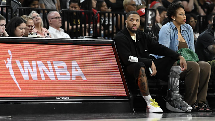 May 30, 2025; Las Vegas, Nevada, USA; NBA player Damian Lillard sits courtside during the Las Vegas Aces and Los Angeles Sparks game at Michelob Ultra Arena. Mandatory Credit: Candice Ward-Imagn Images