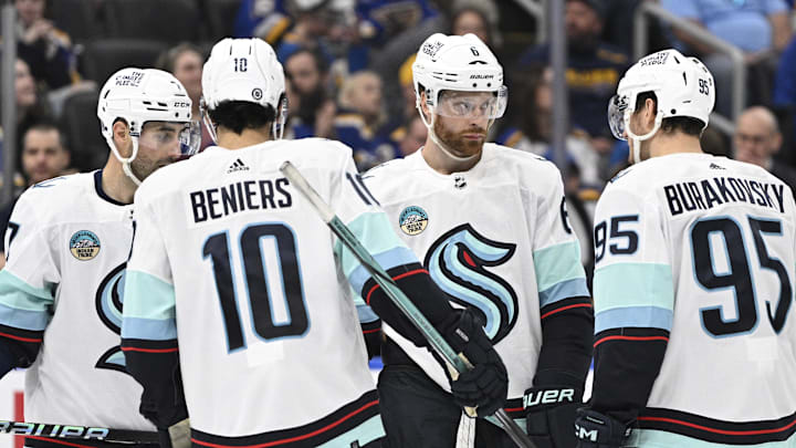 Apr 14, 2024; St. Louis, Missouri, USA; Seattle Kraken defenseman Adam Larsson (6) looks on with center Matty Beniers (10) and left wing Andre Burakovsky (95) during the thrid period of a hockey game against the St. Louis Blues at Enterprise Center. Mandatory Credit: Jeff Le-Imagn Images