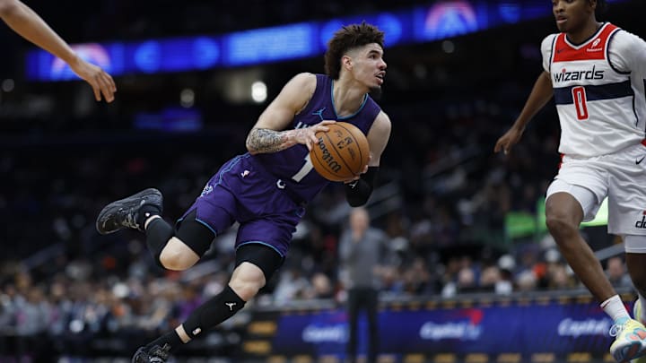 Dec 19, 2024; Washington, District of Columbia, USA; Charlotte Hornets guard LaMelo Ball (1) drives to the basket as Washington Wizards guard Bilal Coulibaly (0) defends in the second quarter at Capital One Arena. Mandatory Credit: Geoff Burke-Imagn Images Dec 19, 2024; Washington, District of Columbia, USA; Charlotte Hornets guard LaMelo Ball (1) drives to the basket as Washington Wizards guard Bilal Coulibaly (0) defends in the second quarter at Capital One Arena. Mandatory Credit: Geoff Burke-Imagn Images