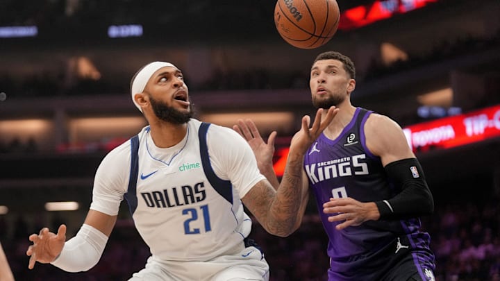 Jan 6, 2026; Sacramento, California, USA; Dallas Mavericks forward Daniel Gafford (21) loses control of the ball next to Sacramento Kings guard Zach LaVine (8) in the first quarter at the Golden 1 Center. Mandatory Credit: Cary Edmondson-Imagn Images