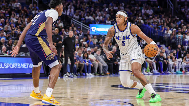 Jan 11, 2026; Orlando, Florida, USA; Orlando Magic forward Paolo Banchero (5) moves the ball in front of New Orleans Pelicans center Derik Queen (22) during the second half at Kia Center. Mandatory Credit: Mike Watters-Imagn Images