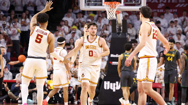 Feb 7, 2026; Ames, Iowa, USA; Iowa State Cyclones forward Joshua Jefferson (5) and Iowa State Cyclones forward Milan Momcilovic (22) wait to celebrate with Iowa State Cyclones guard Nate Heise (0) after the basket in their game with the Baylor Bears during the second half at James H. Hilton Coliseum.