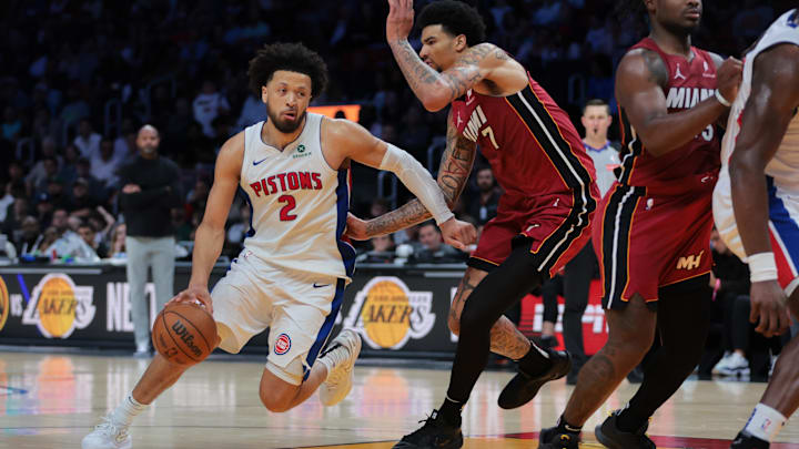 Mar 19, 2025; Miami, Florida, USA; Detroit Pistons guard Cade Cunningham (2) drives to the basket past Miami Heat center Kel'el Ware (7) during the fourth quarter at Kaseya Center. Mandatory Credit: Sam Navarro-Imagn Images