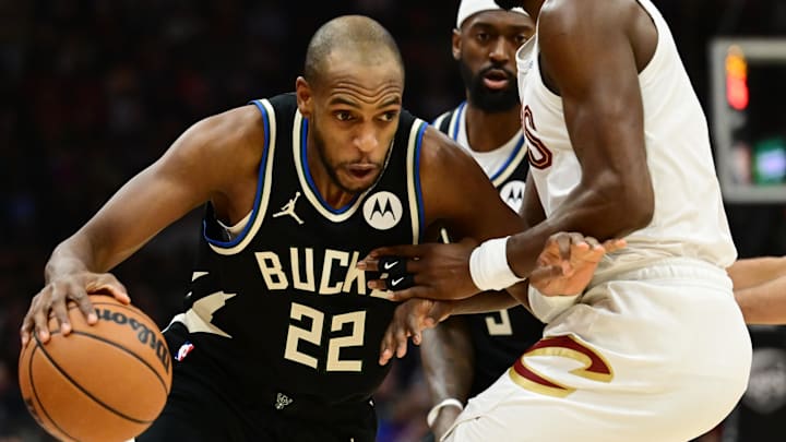 Dec 20, 2024; Cleveland, Ohio, USA; Milwaukee Bucks forward Khris Middleton (22) drives to the basket against Cleveland Cavaliers guard Caris LeVert (3) during the first half at Rocket Mortgage FieldHouse. Mandatory Credit: Ken Blaze-Imagn Images