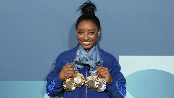 Aug 5, 2024; Paris, France; Simone Biles of the United States poses for a photo with her three gold and one silver medal after day three of the gymnastics event finals during the Paris 2024 Olympic Summer Games. Mandatory Credit: Kyle Terada-Imagn Images