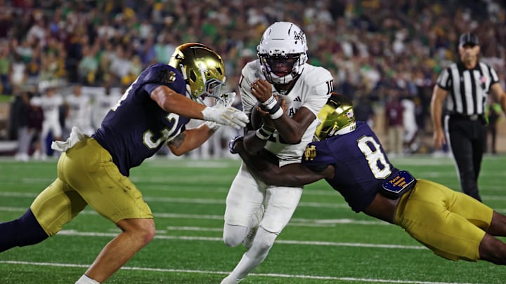 Sep 13, 2025; South Bend, Indiana, USA; Texas A&M Aggies quarterback Marcel Reed (10) runs the ball as Notre Dame Fighting Irish safety Adon Shuler (8) goes for a tackle during the second half at Notre Dame Stadium. Mandatory Credit: Trevor Ruszkowski-Imagn Images Sep 13, 2025; South Bend, Indiana, USA; Texas A&M Aggies quarterback Marcel Reed (10) runs the ball as Notre Dame Fighting Irish safety Adon Shuler (8) goes for a tackle during the second half at Notre Dame Stadium. Mandatory Credit: Trevor Ruszkowski-Imagn Images