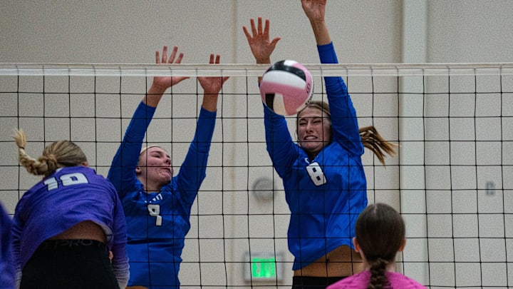 Iowa City Liberty's Ellie Wilson spikes the ball against Dike-New Hartford's Kailyn Meester (9) and Rylee Reicks (8) during a tournament at Ankeny Centennial High School on Aug. 30, 2025, in Ankeny.