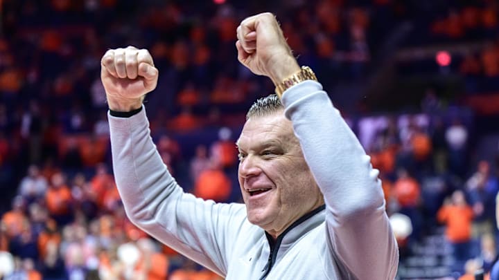 Jan 21, 2026; Champaign, Illinois, USA;  Illinois Fighting Illini head coach Brad Underwood greets fans as he enters the floor during pre-game introductions at State Farm Center in a matchup against the Maryland Terrapins.. Mandatory Credit: Fred Zwicky-Imagn Images