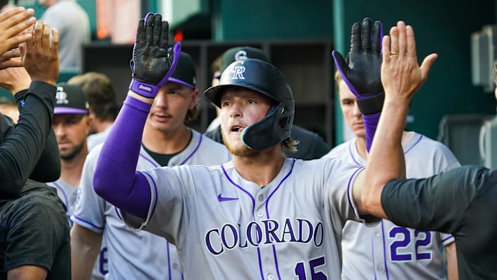 May 12, 2025; Arlington, Texas, USA; Colorado Rockies catcher Hunter Goodman (15) high fives teammates after scoring during the second inning against the Texas Rangers at Globe Life Field. Mandatory Credit: Raymond Carlin III-Imagn Images