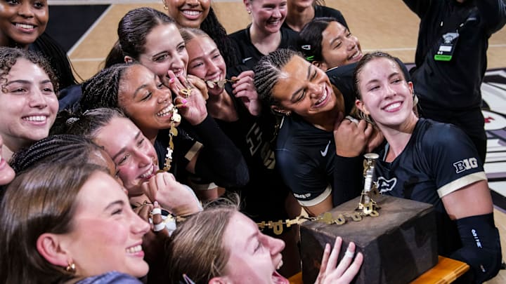 The Purdue Boilermakers pose with the trophy after winning the Monon Spike Match against the Indiana Hoosiers