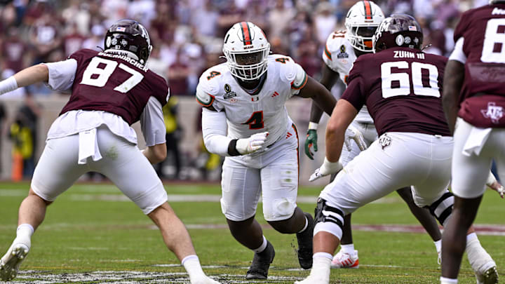 Dec 20, 2025; College Station, TX, USA; Miami Hurricanes defensive lineman Rueben Bain Jr. (4) rushes the line past Texas A&M Aggies tight end Nate Boerkircher (87) and offensive lineman Trey Zuhn III (60) during the game between the Aggies and the Hurricanes at Kyle Field. Mandatory Credit: Jerome Miron-Imagn Images