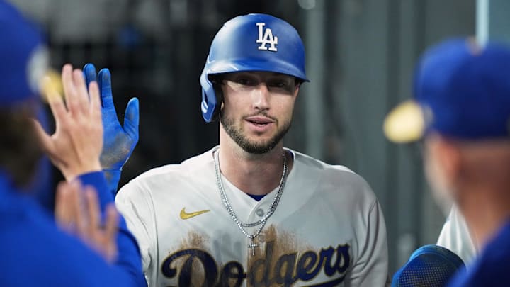 Mar 26, 2026; Los Angeles, California, USA; Los Angeles Dodgers outfielder Kyle Tucker (23) shakes hands with teammates in the dugout after scoring a run against the Arizona Diamondbacks during the seventh inning at Dodger Stadium. Mandatory Credit: Kirby Lee-Imagn Images