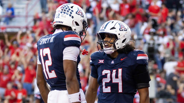 Nov 8, 2025; Tucson, Arizona, USA; Arizona Wildcats running back Quincy Craig (24) celebrates with wide receiver Tre Spivey (12) after rushing for a touchdown against the Kansas Jayhawks in the second half at Arizona Stadium. Mandatory Credit: Mark J. Rebilas-Imagn Images