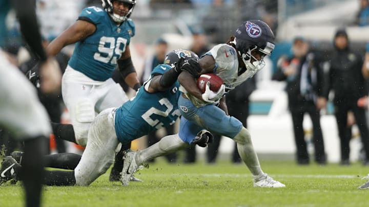Dec 29, 2024; Jacksonville, Florida, USA; Jacksonville Jaguars linebacker Foyesade Oluokun (23) tackles Tennessee Titans running back Tyjae Spears (2) during the second quarter at EverBank Stadium. Mandatory Credit: Morgan Tencza-Imagn Images Dec 29, 2024; Jacksonville, Florida, USA; Jacksonville Jaguars linebacker Foyesade Oluokun (23) tackles Tennessee Titans running back Tyjae Spears (2) during the second quarter at EverBank Stadium. Mandatory Credit: Morgan Tencza-Imagn Images