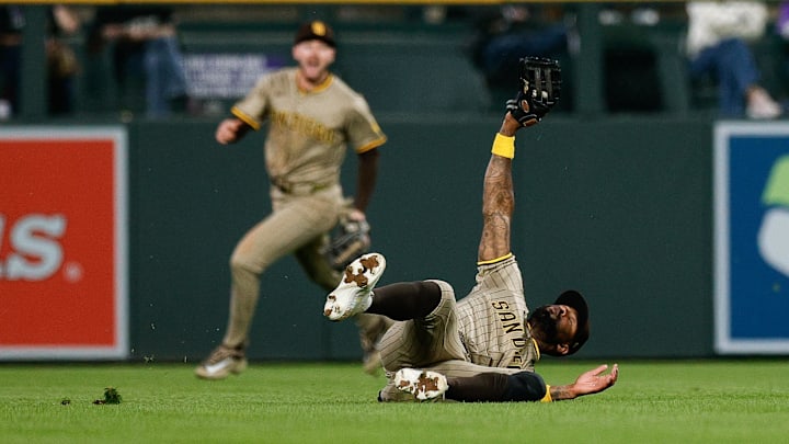 May 9, 2025; Denver, Colorado, USA; San Diego Padres left fielder Jason Heyward (22) makes a diving catch in the fifth inning against the Colorado Rockies at Coors Field. Mandatory Credit: Isaiah J. Downing-Imagn Images