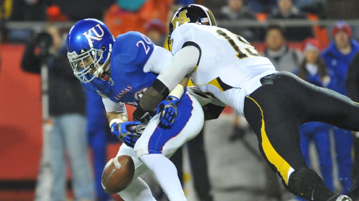 Missouri Tigers linebacker Donovan Bonner (15) forces Kansas Jayhawks wide receiver D.J. Beshears (20) to fumble.