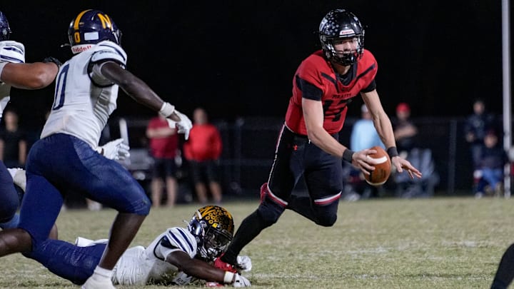 Naples Golden Eagles defensive back Tariq Arbyummi (3) dives and sacks Port Charlotte Pirates quarterback Logan Flaherty (17) during the fourth quarter of the Class 4A Region 3 championship at Port Charlotte High School in Port Charlotte, Fla., on Friday, Nov. 29, 2024.